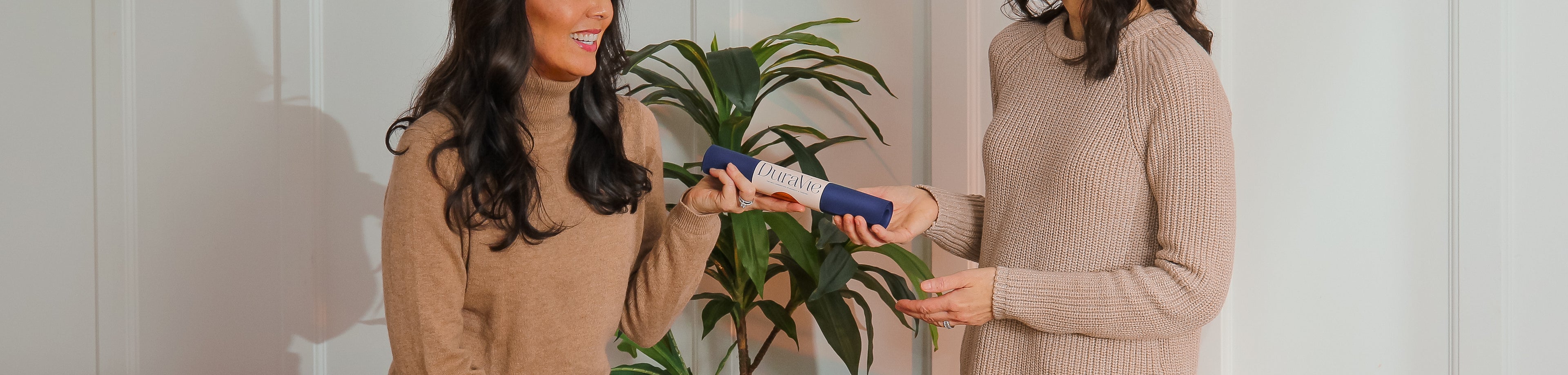 Wellness professional introducing DuraVie reusable silicone drape as a sustainable alternative to towels