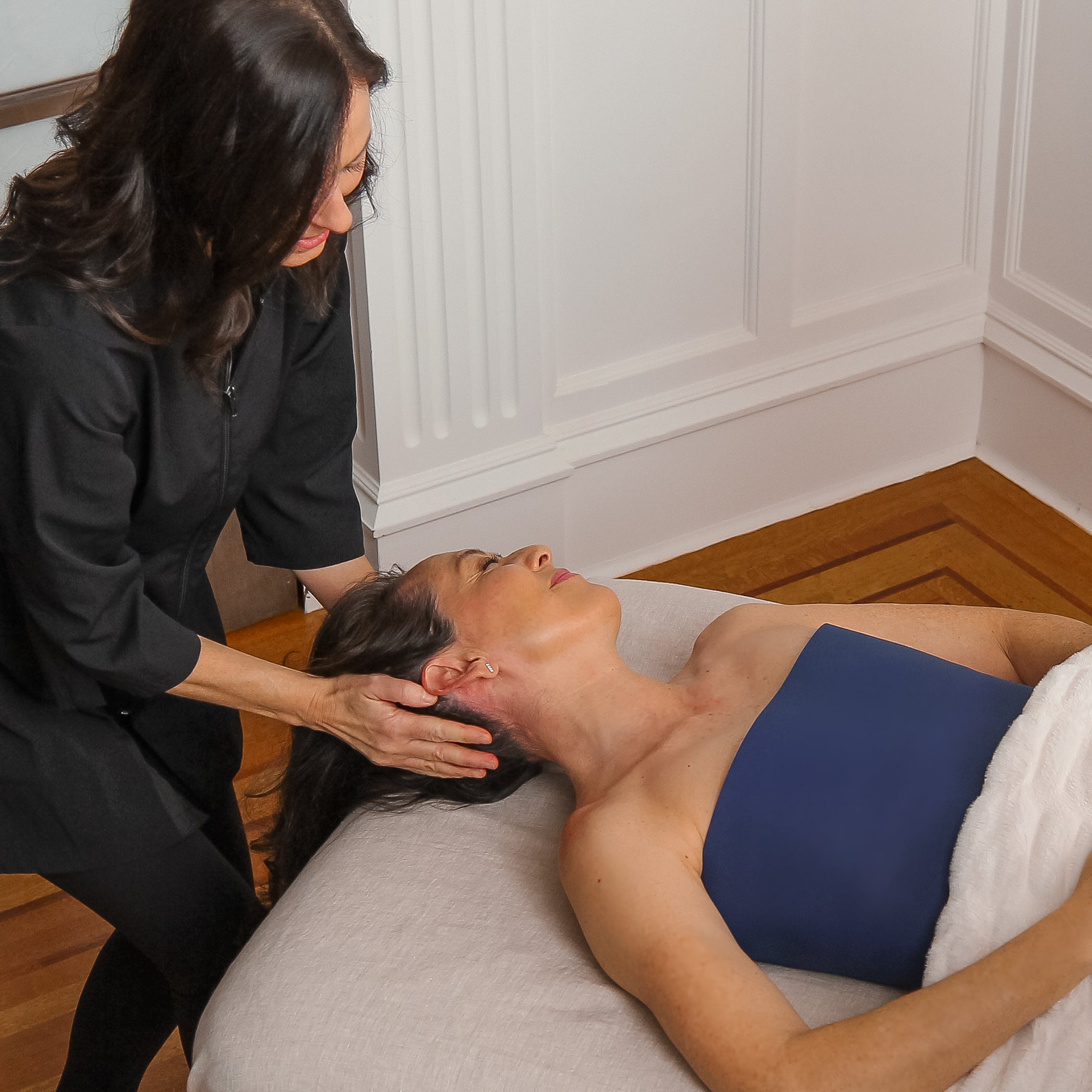 Massage therapist using DuraVie silicone drape during body treatment
